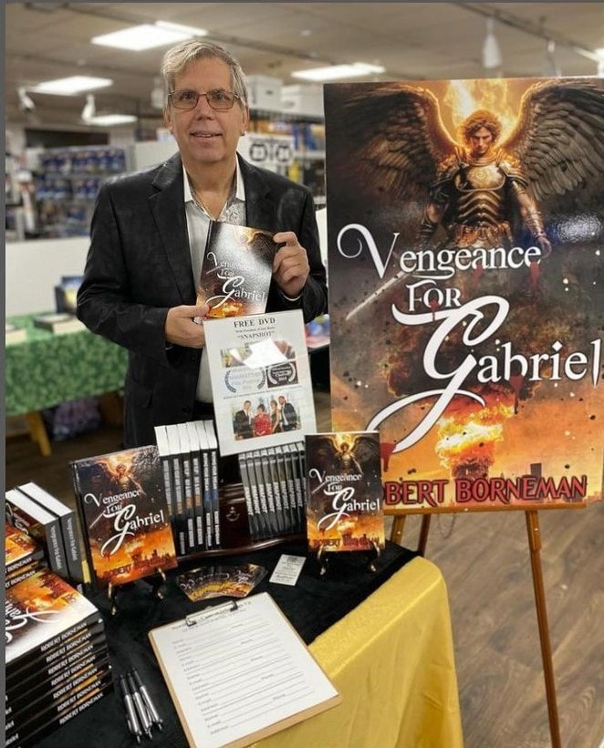 Robert Borneman signing his book at a desk